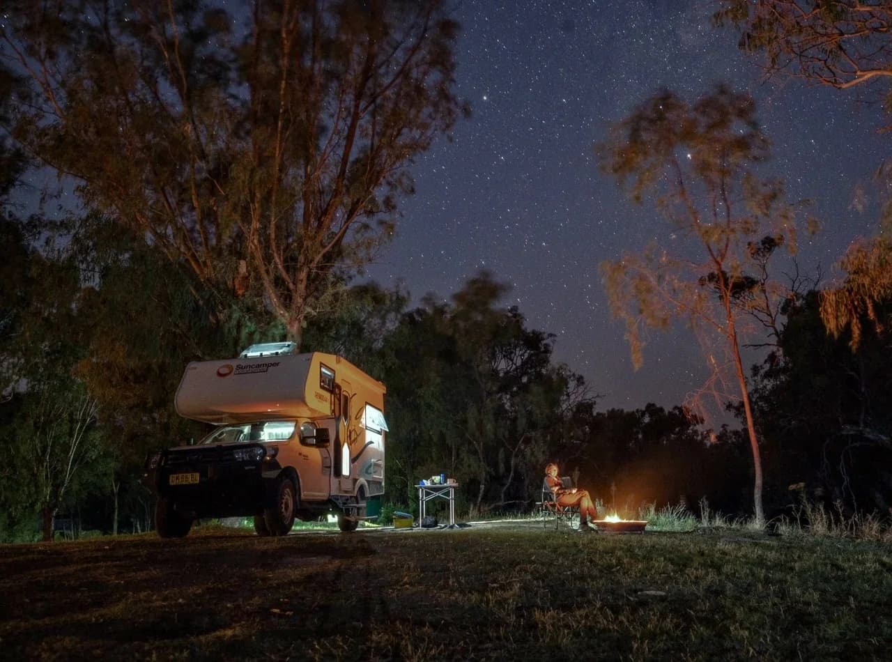 Suncamper reflected in still water at a golden-hour river camp, Billbourie