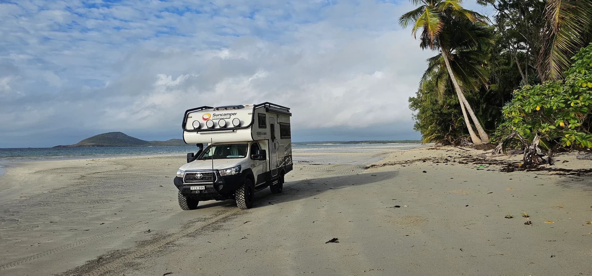 Suncamper parked on the tropical sands of Chili Beach, Iron Range National Park, Cape York
