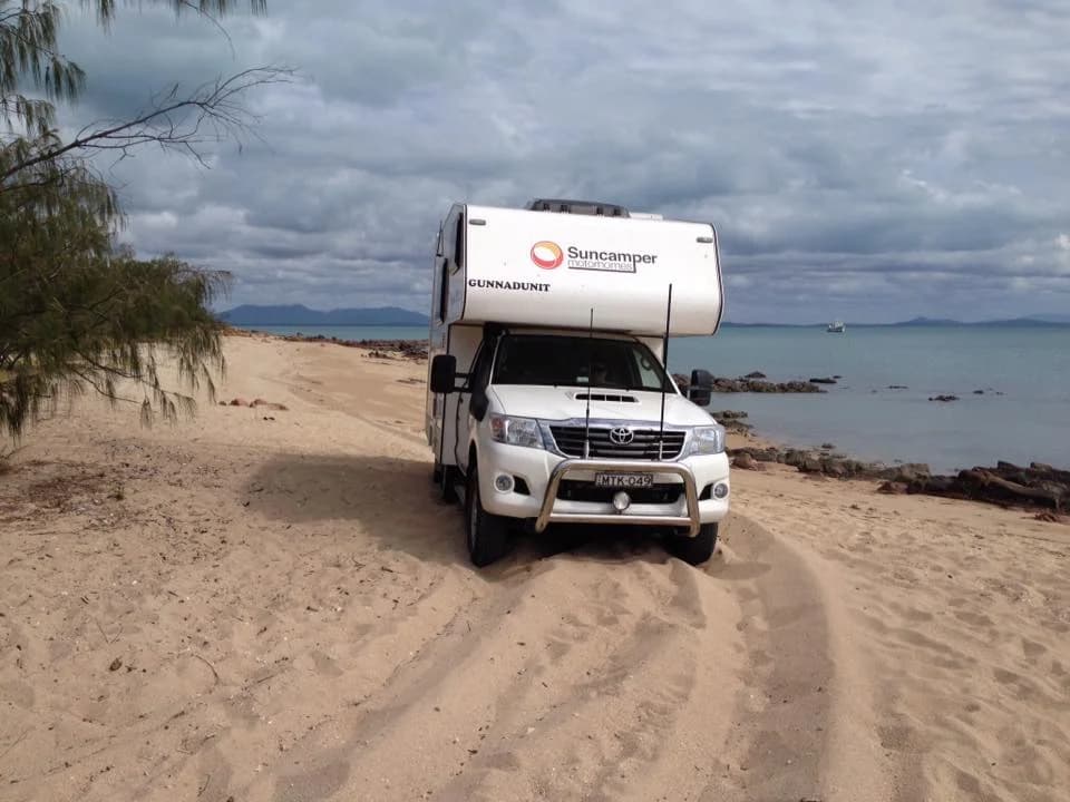 Sherwood 4x4 beach driving in Far North Queensland with islands and a ship in the backdrop