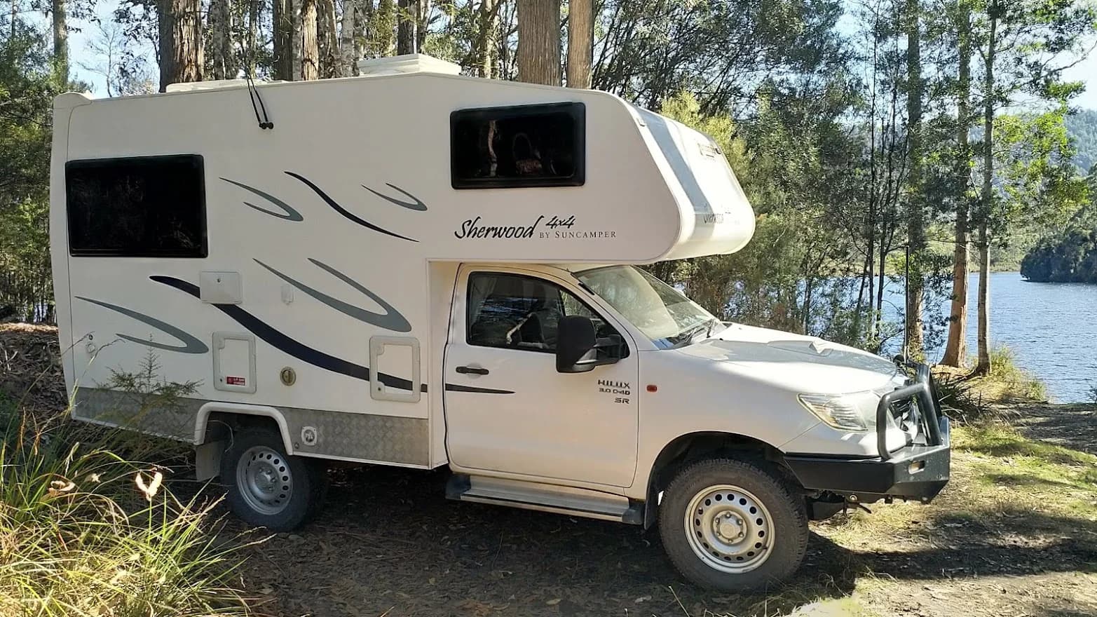 Suncamper Sherwood on the shoreline at Lake Rosebery, Tasmania