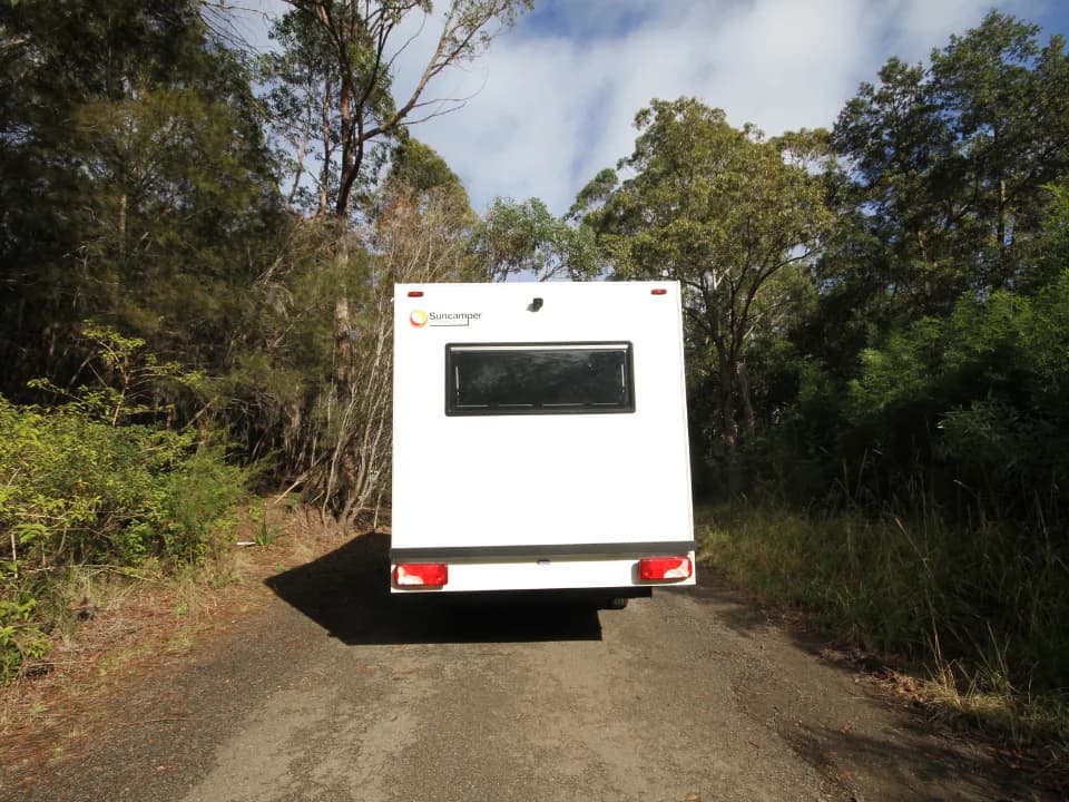 Suncamper Saxby F-2 rear exterior on bush road — exterior