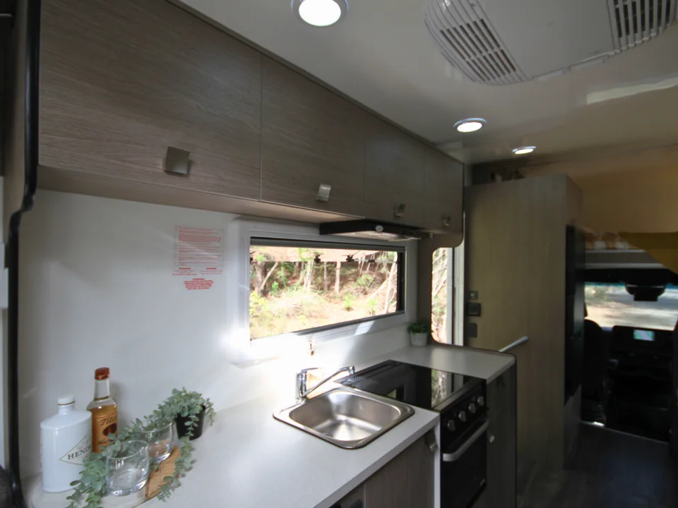 Suncamper Saxby F-2 kitchen counter with sink and cooktop — kitchen