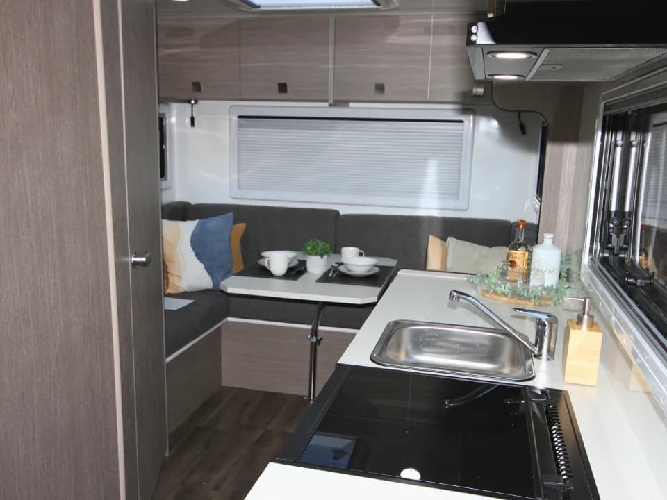 Suncamper Saxby F-2 kitchen sink and induction hob detail — kitchen