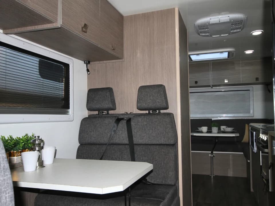 Suncamper Saxby F-2 travel seating looking toward lounge — interior